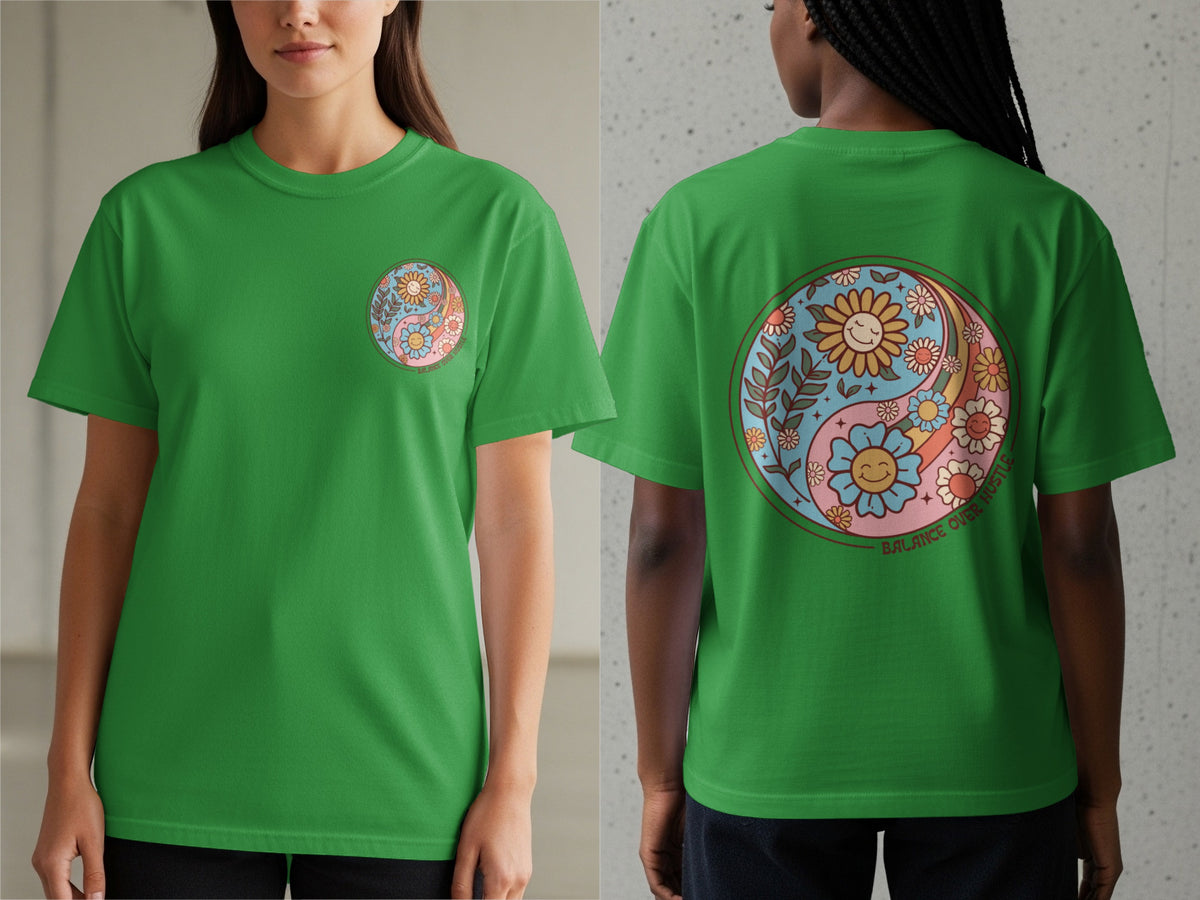 Green t-shirt with yin-yang design featuring smiling flowers, leaves, and rainbow. Text: BALANCE OVER HUSTLE.