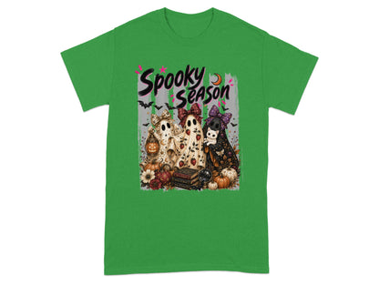 "Spooky Season" text with three ghosts, a cat, pumpkins, and books on a green t-shirt.