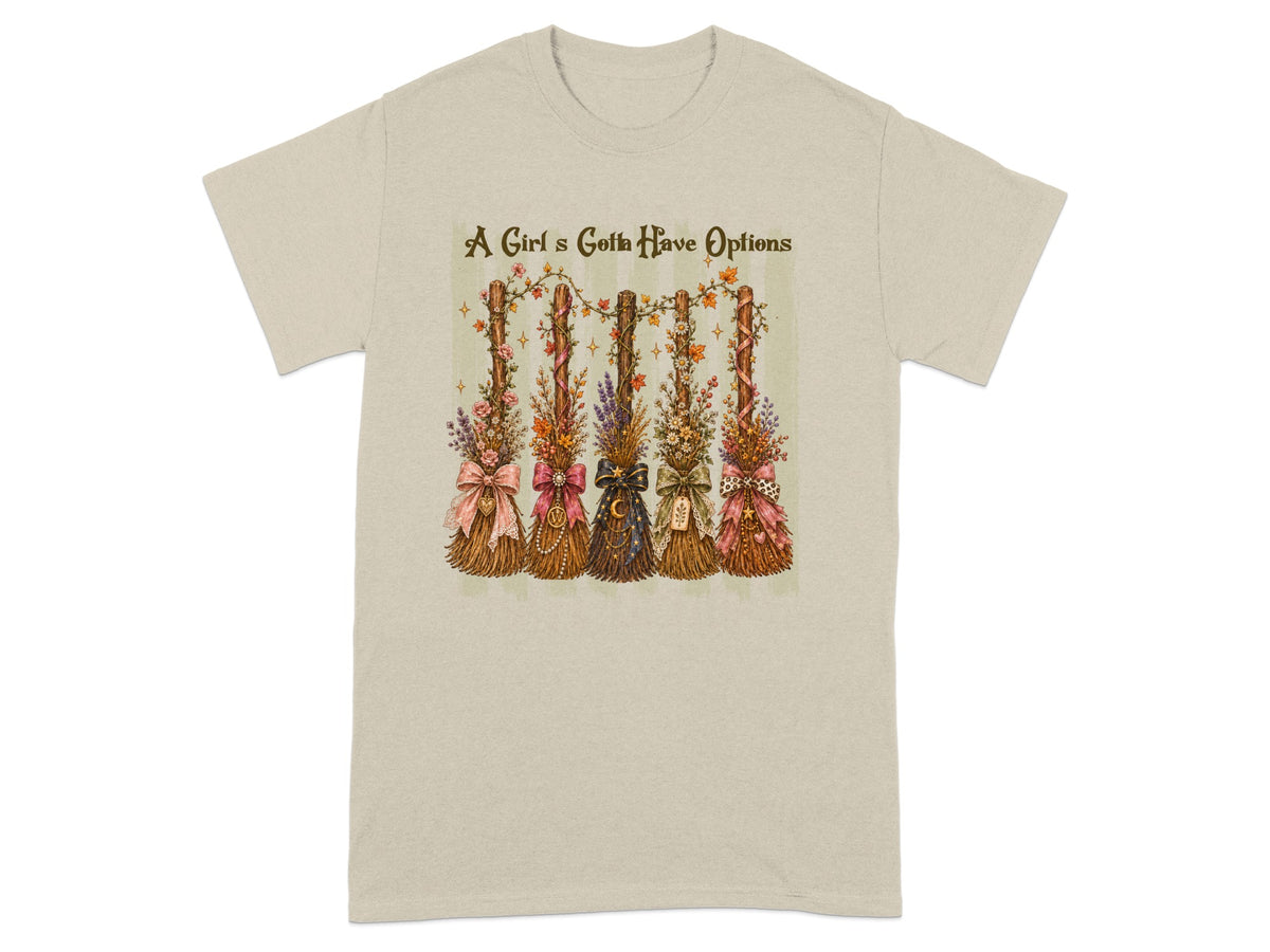 A Girl's Gotta Have Options text above five decorated brooms on a t-shirt.
