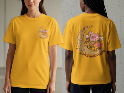 Yellow t-shirt with a crescent moon, flowers, and the text "Take a moment to breathe."