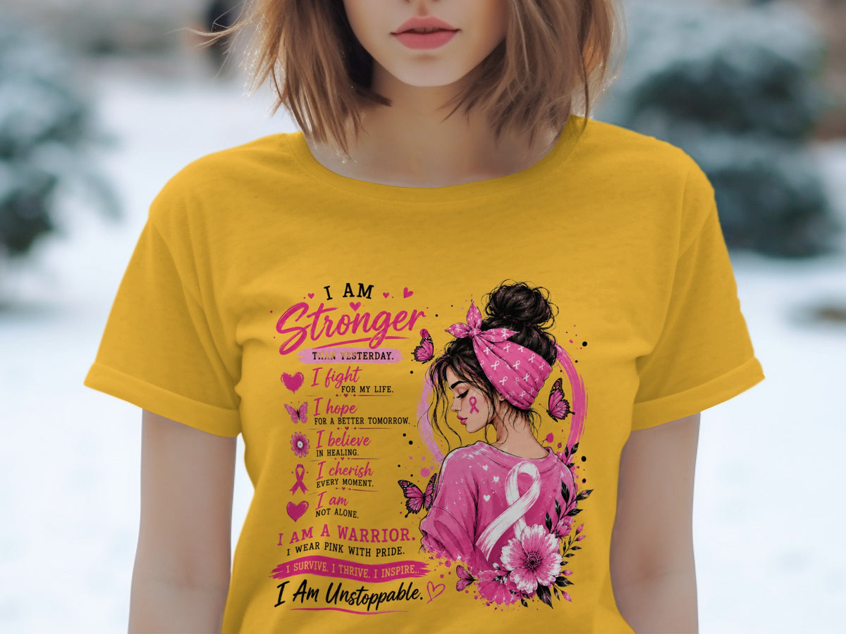 Yellow t-shirt with "I Am Stronger Than Yesterday" and breast cancer awareness graphic.