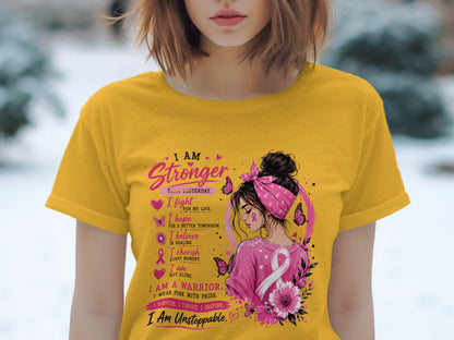 Yellow t-shirt with "I Am Stronger Than Yesterday" and breast cancer awareness graphic.