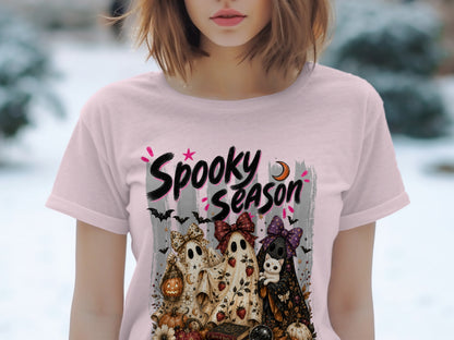 T-shirt with "Spooky Season" graphic featuring ghosts, a cat, pumpkins, and bats.