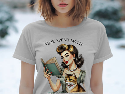 Gray t-shirt with retro illustration of woman reading book with cat, text "TIME SPENT WITH".