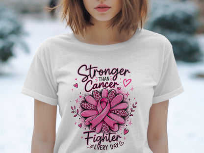 T-shirt with "Stronger Than Cancer Fighter Every Day" text and pink ribbon flower graphic.