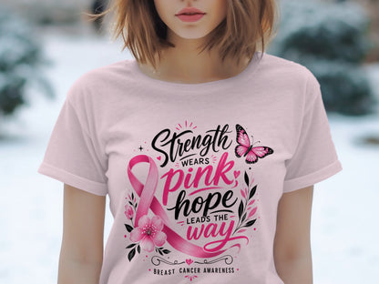 Pink breast cancer awareness t-shirt with "Strength Wears Pink, Hope Leads the Way" text.