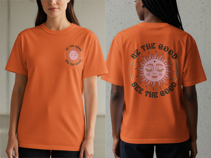Orange t-shirt with a sun graphic and text "BE THE GOOD SEE THE GOOD".