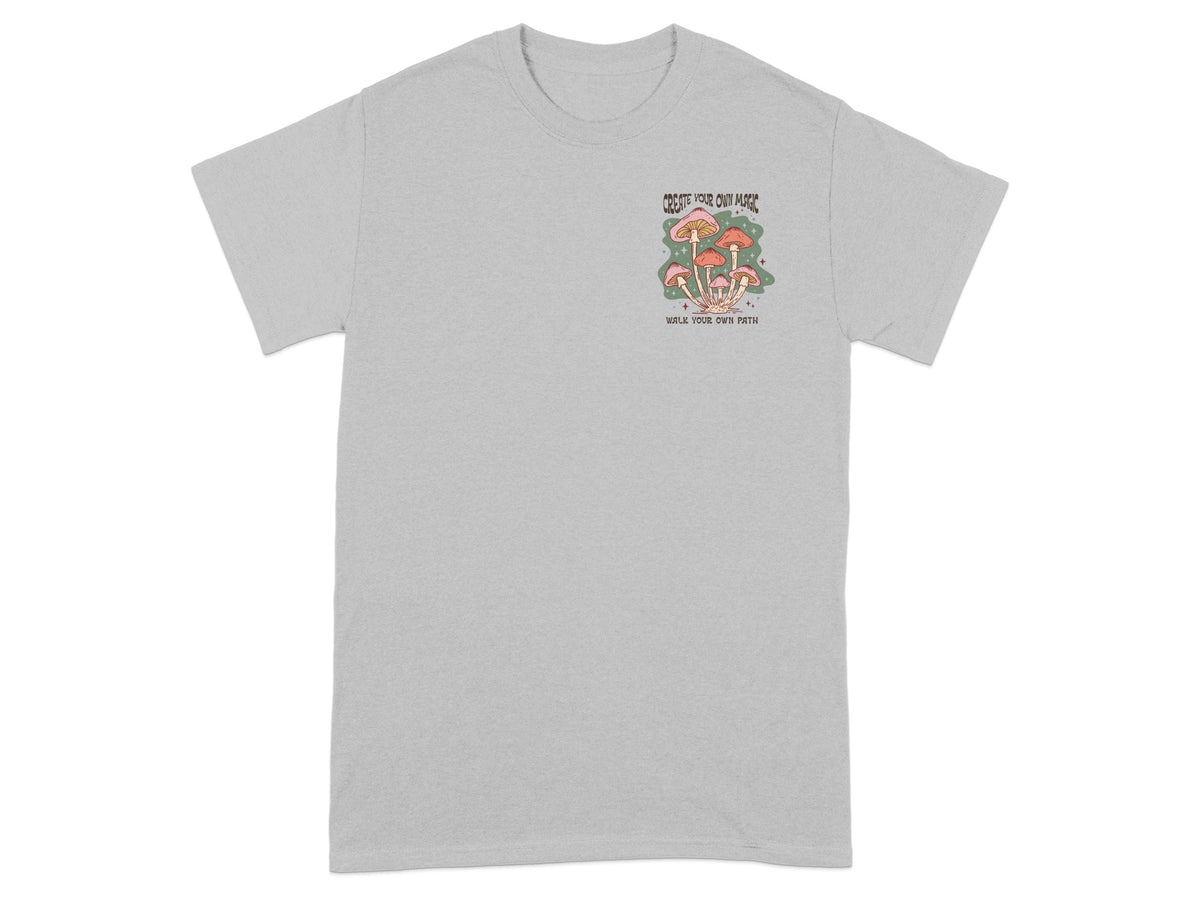 Grey t-shirt with mushroom graphic and text "CREATE YOUR OWN MAGIC WALK YOUR OWN PATH".