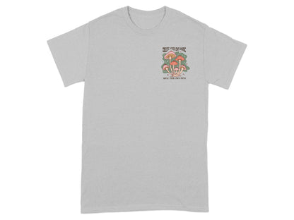 Grey t-shirt with mushroom graphic and text "CREATE YOUR OWN MAGIC WALK YOUR OWN PATH".
