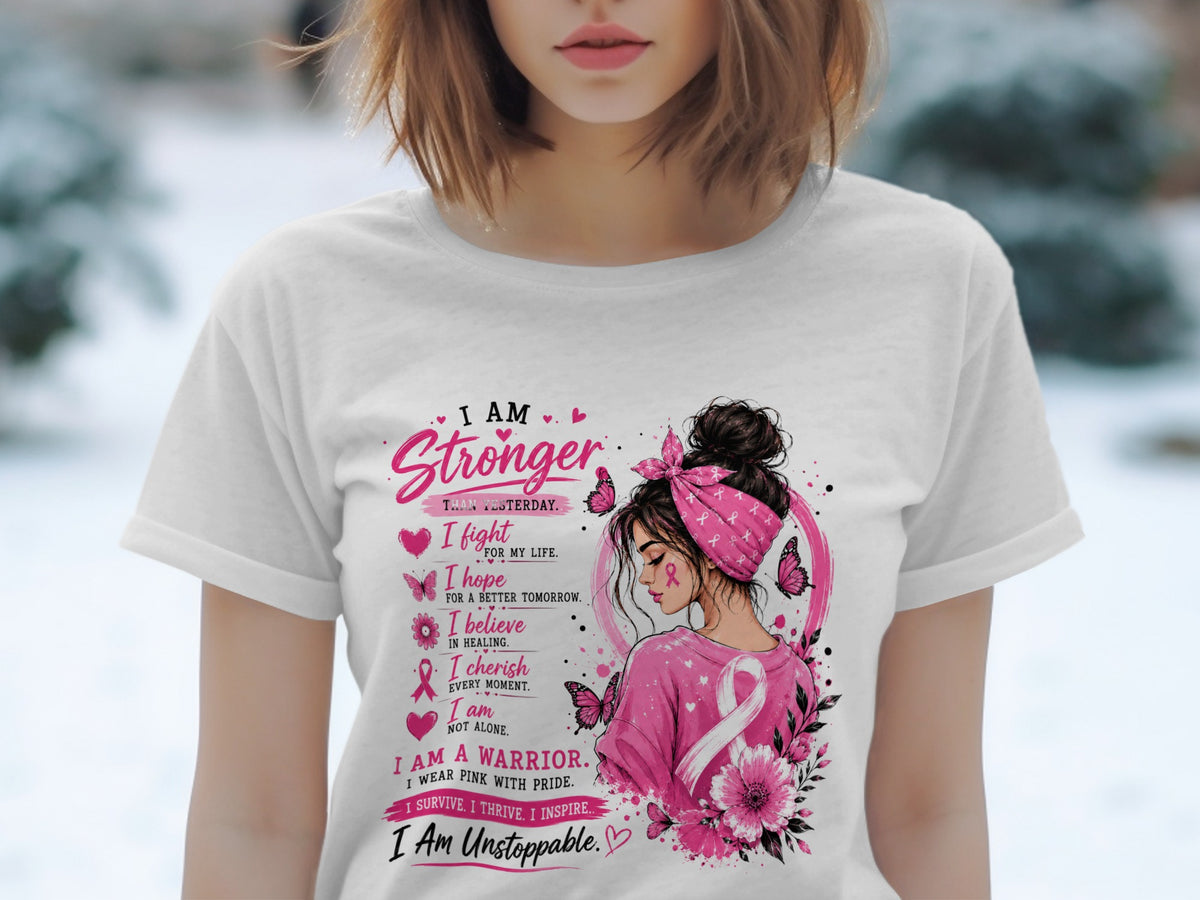 Woman wearing a white t-shirt with pink breast cancer awareness design and text.