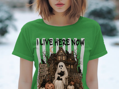 Green t-shirt with ghost, black cats, haunted house, and "I LIVE HERE NOW" text.