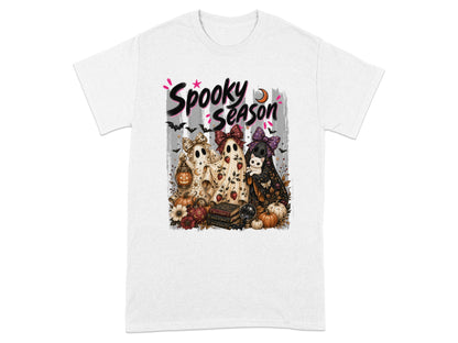 Three ghosts dressed in bows and Halloween costumes stand with pumpkins and flowers.