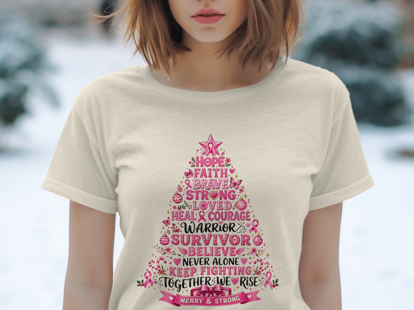 T-shirt with a pink Christmas tree graphic listing inspirational words like "Warrior" and "Survivor".