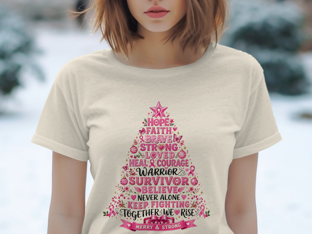 T-shirt with a pink Christmas tree graphic listing inspirational words like "Warrior" and "Survivor".
