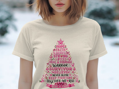 T-shirt with a pink Christmas tree graphic listing inspirational words like "Warrior" and "Survivor".
