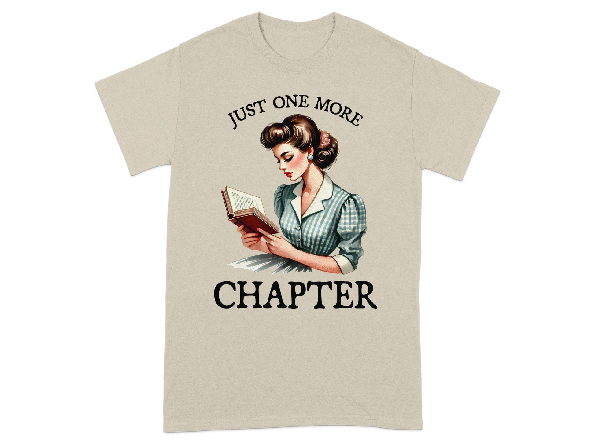 Light beige t-shirt with retro illustration and text "JUST ONE MORE CHAPTER".