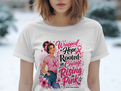 White t-shirt with woman and text: "Wrapped in Hope, Rooted in Courage, Rising in Pink. Breast Cancer Awareness."