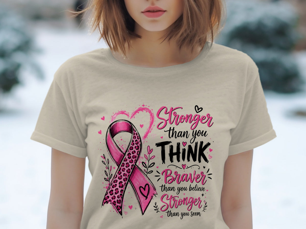 T-shirt graphic with pink ribbon, text "Stronger than you think", "Braver than you believe".