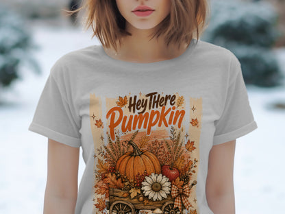 "Hey There Pumpkin" text with pumpkin and fall foliage in a wagon on a t-shirt.