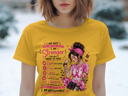 Yellow t-shirt with "I am stronger than what it tried to take" graphic.
