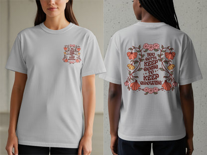 Light gray t-shirt with a floral design and "YOU GOTTA KEEP GOING TO KEEP GROWING" text.
