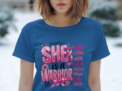 Blue t-shirt with pink text "SHE is a WARRIOR" and empowering words.