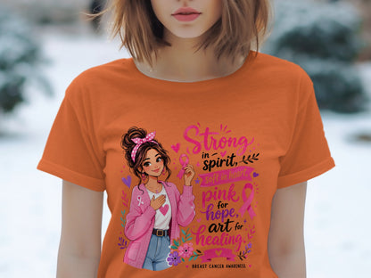 Orange t-shirt with breast cancer awareness graphic of woman, pink ribbon, and text.