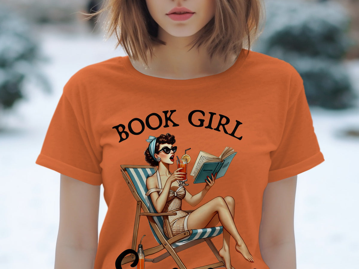 Orange t-shirt with "BOOK GIRL" text and a pin-up girl reading in a beach chair.