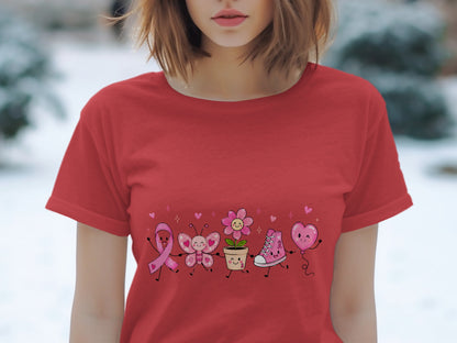 Red t-shirt with pink ribbon, butterfly, flower, sneaker, and heart balloon graphic.