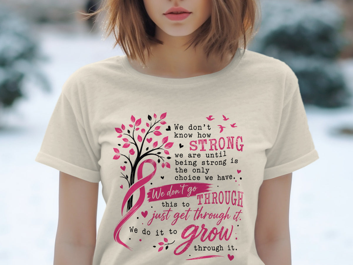 T-shirt with pink breast cancer ribbon tree and empowering text about strength and growth.