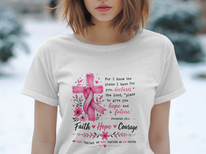White t-shirt with pink ribbon, cross, flowers, and text about hope and courage.