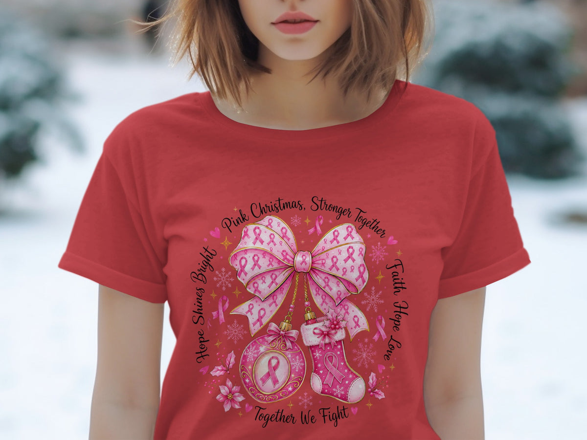 Red t-shirt with circular design of pink ribbons, bow, ornament, and stocking with text.