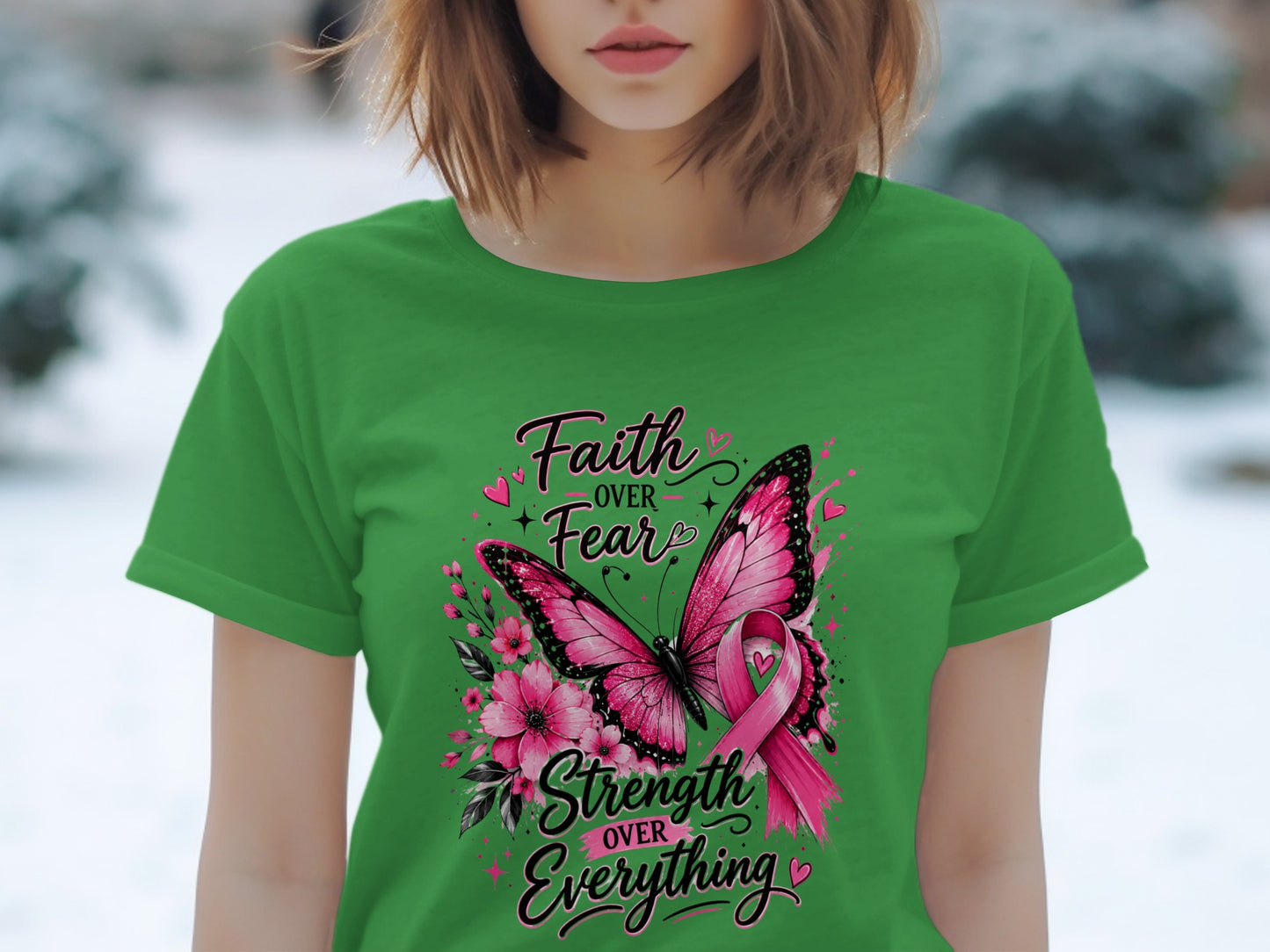 Green t-shirt with butterfly, flowers, and "Faith over Fear, Strength over Everything" text.