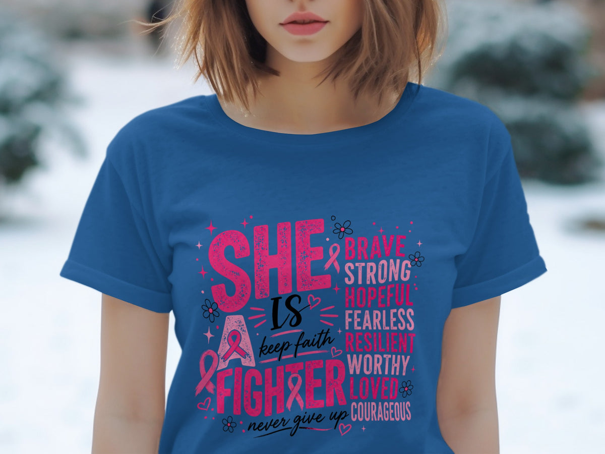 Blue t-shirt with pink text "She is a fighter" and empowering words.