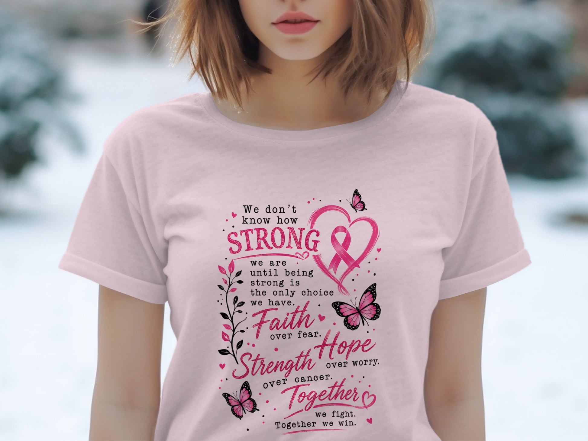 Pink t-shirt with breast cancer awareness text and graphics.