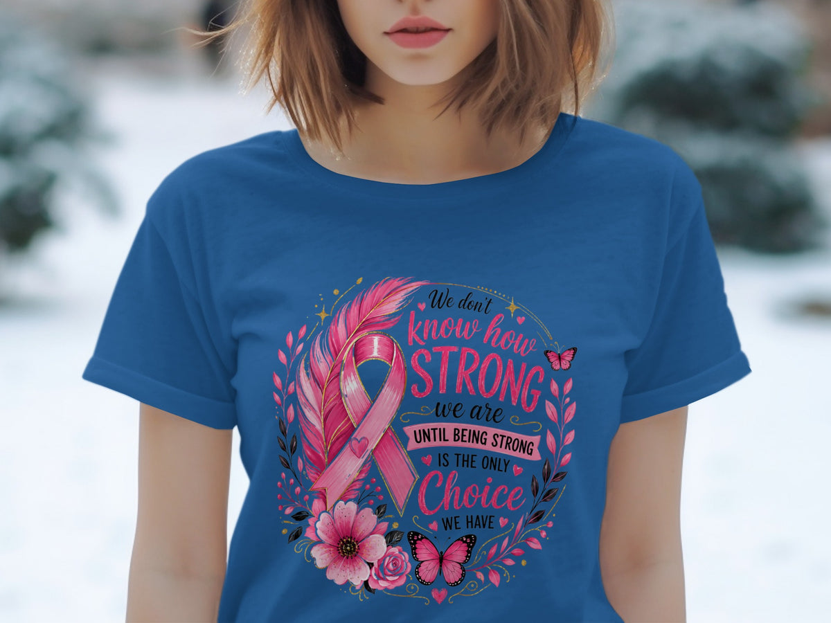 Blue t-shirt with pink breast cancer ribbon, feathers, flowers, butterflies, and empowering text.