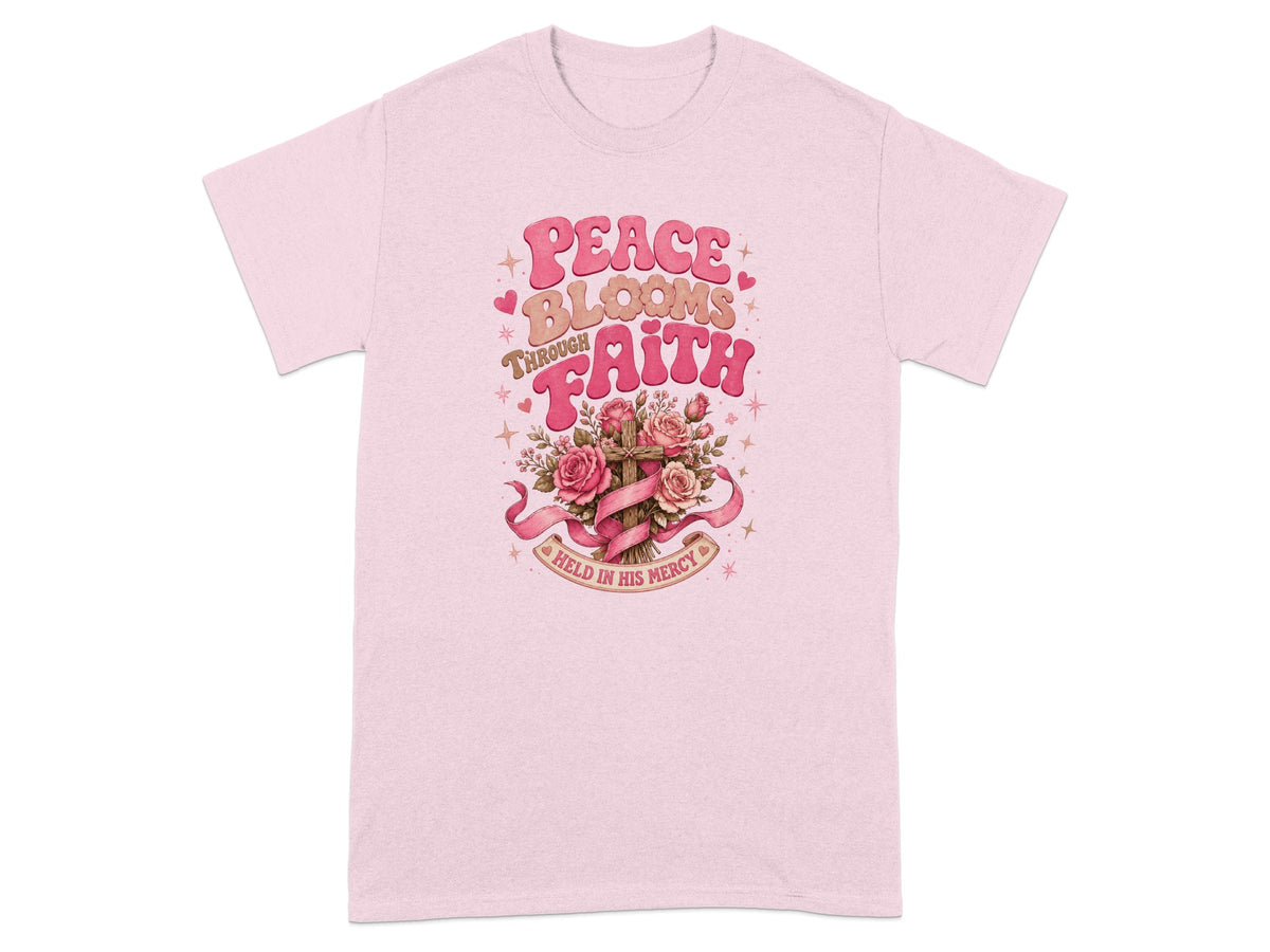 Pink t-shirt with "Peace Blooms Through Faith Held In His Mercy" text and floral cross graphic.