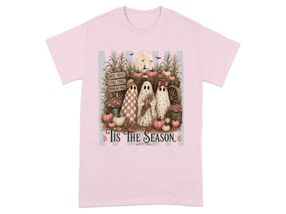 Three ghosts and pumpkins sit in a wagon with fall harvest elements.