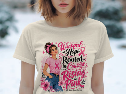 T-shirt with "Wrapped in Hope, Rooted in Courage, Rising in Pink" text and breast cancer awareness ribbon.