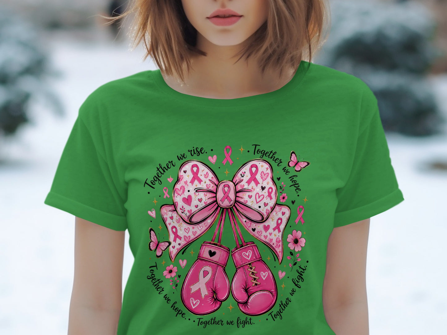 Green t-shirt with pink boxing gloves, bow, butterflies, flowers, and breast cancer ribbons.