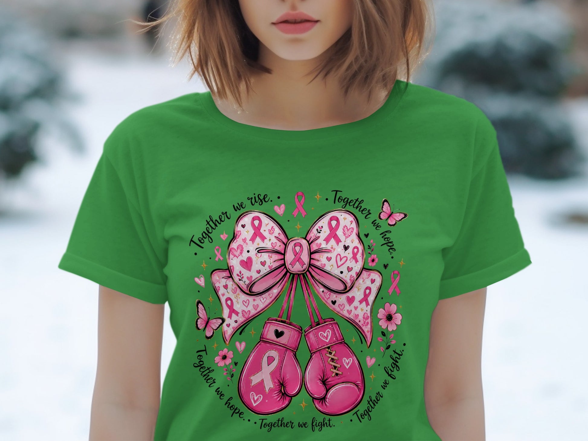 Green t-shirt with pink boxing gloves, bow, butterflies, flowers, and breast cancer ribbons.