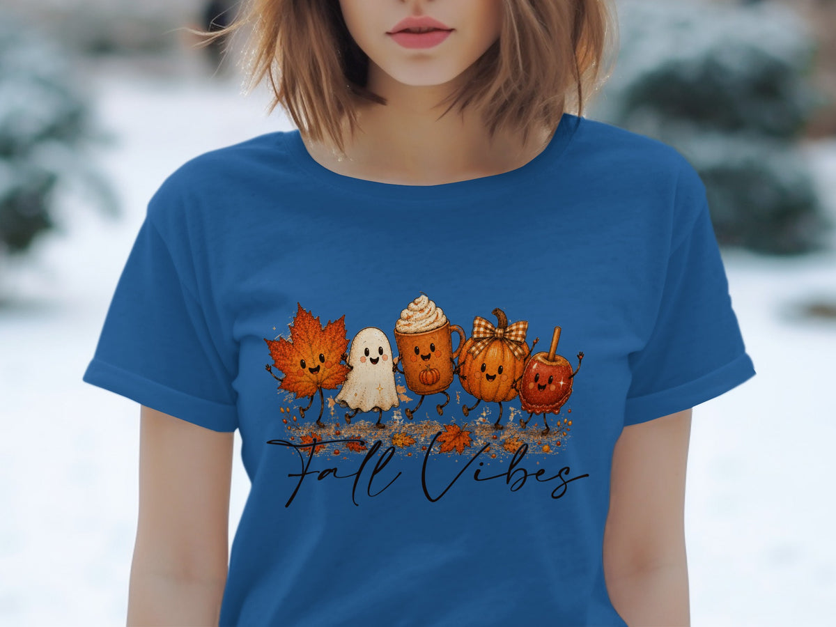 Blue t-shirt with a graphic of a maple leaf, ghost, hot chocolate, pumpkin, and candy apple saying "Fall Vibes".
