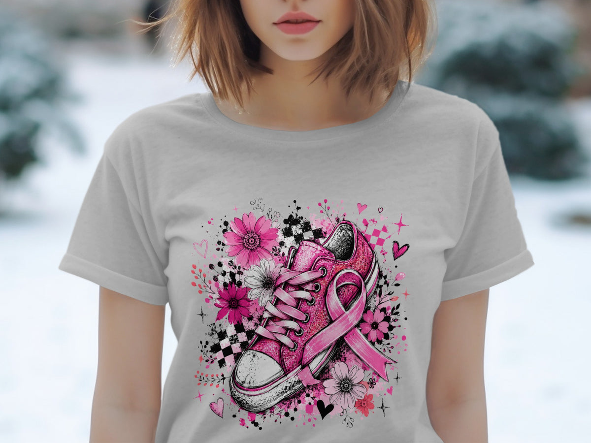 Pink sneaker with ribbon and flowers on a light gray t-shirt.