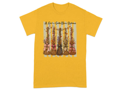 Yellow t-shirt with graphic of five decorated brooms and text "A Girl's Gotta Have Options."