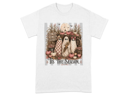 Three ghosts stand among pumpkins, corn stalks, and a wagon, with "Tis The Season" text.
