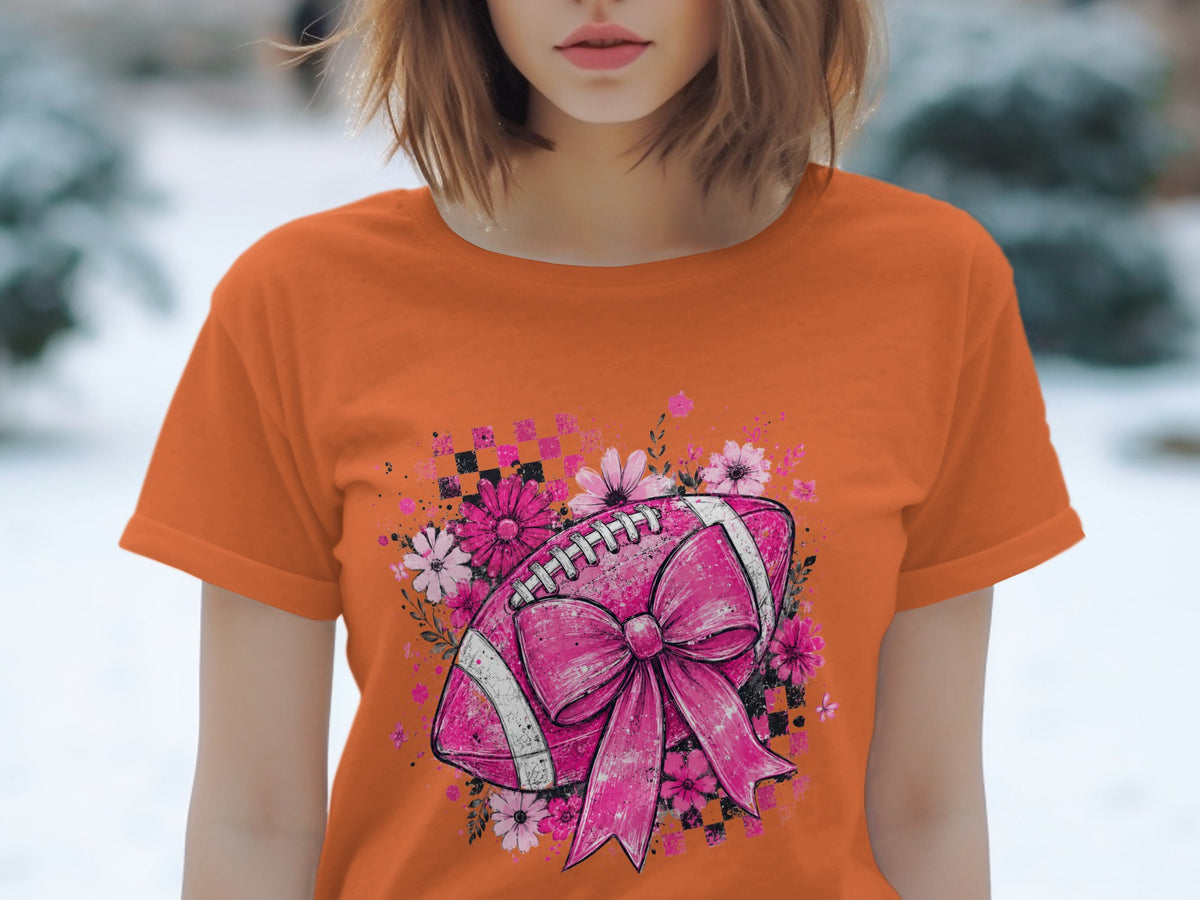 Orange t-shirt with a pink football, bow, and floral design.