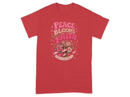 Red t-shirt with "Peace Blooms Through Faith" and a cross with roses.