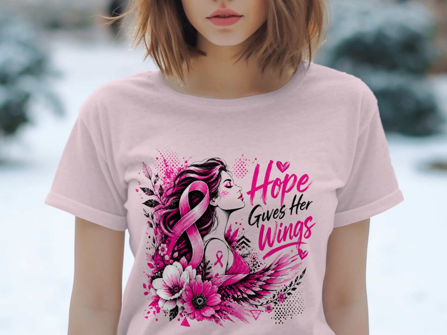 Pink t-shirt with woman, pink ribbon, wings, flowers, and text "Hope Gives Her Wings".