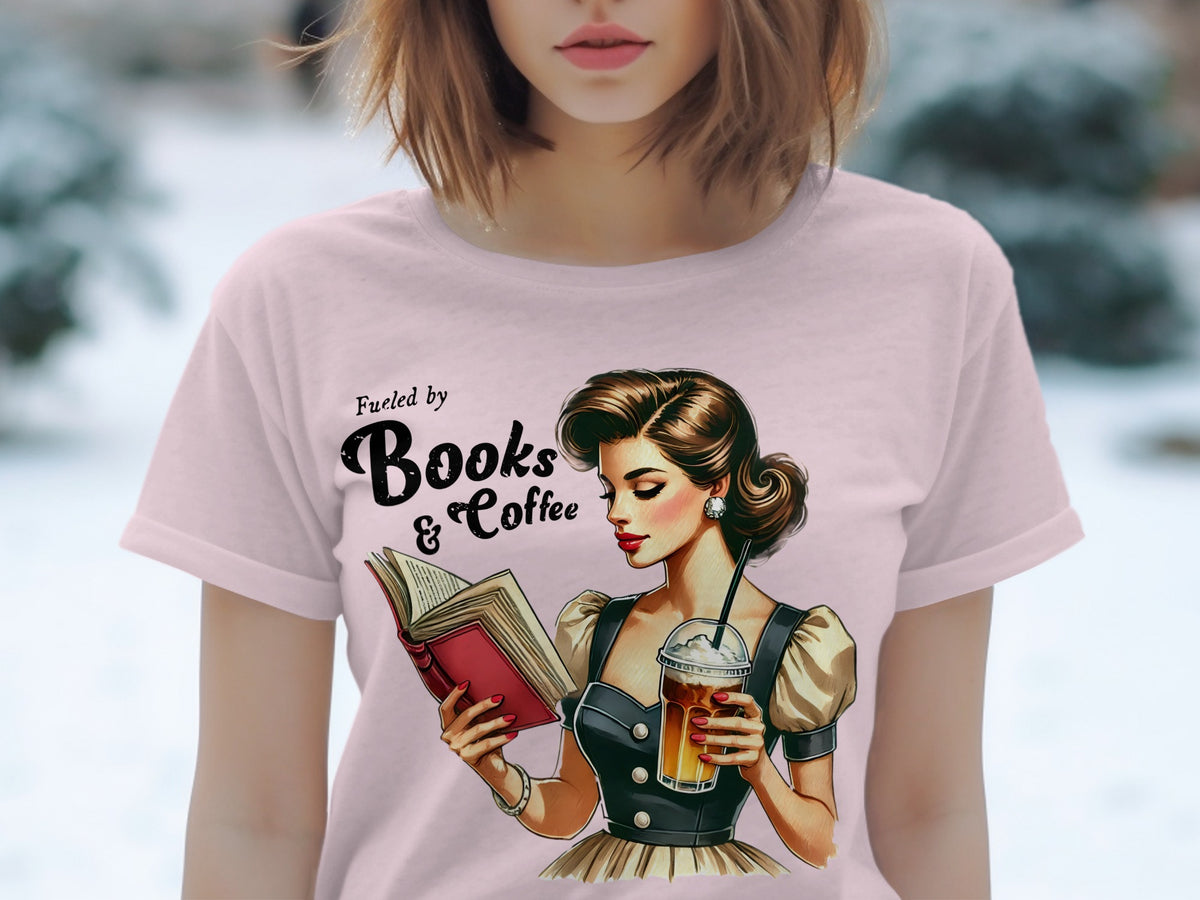 Pink t-shirt with "Fueled by Books & Coffee" text and retro illustration.