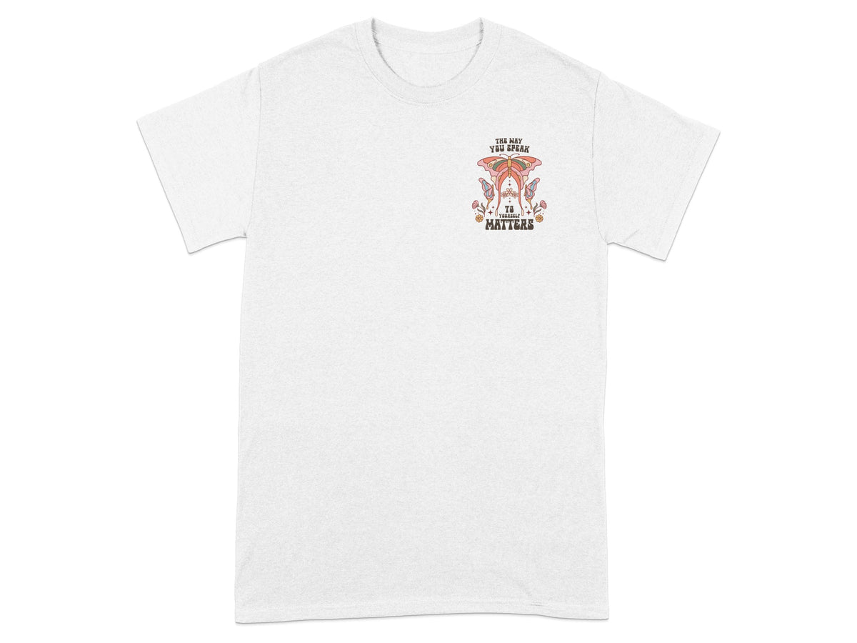 White t-shirt with butterfly graphic and text: "The way you speak to yourself matters".